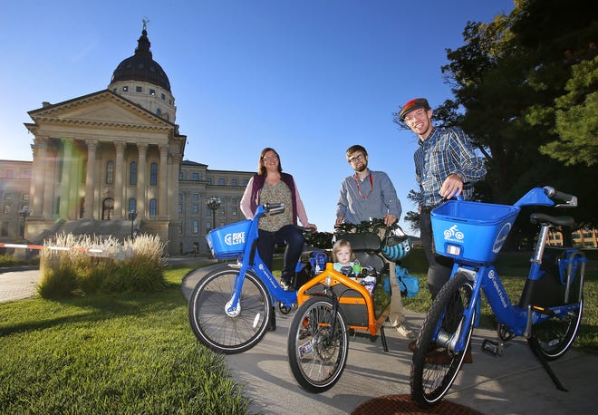 From left, Sara O'Keefe, Andy Fry (with his daughter, Ava) and Karl Fundenberger are members of the Topeka cycling community who have volunteered their time and efforts to improving accessibility and safety for cyclists in the capital city. [Chris Neal/The Capital-Journal]