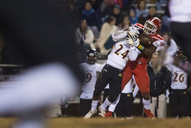 Seventy-First's Camari Williams battles for the ball with Jack Britt's Tyquan Patterson during a first-round playoff game at Seventy-First on Friday. [Melissa Sue Gerrits/The Fayetteville Observer]