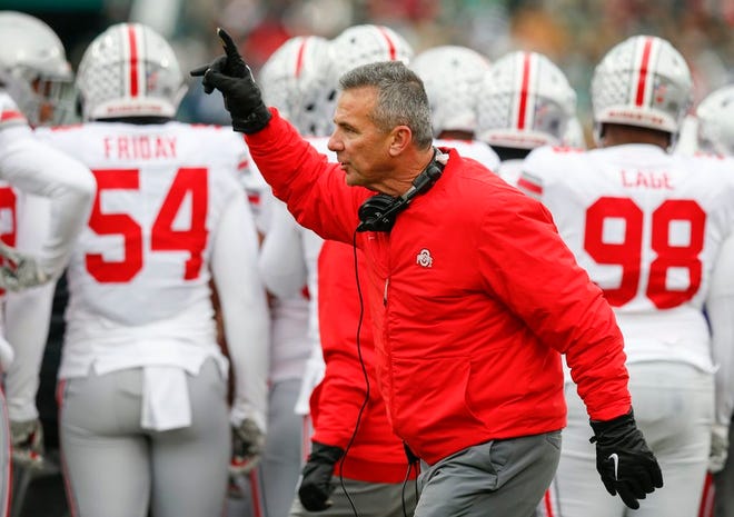 Ohio State Buckeyes head coach Urban Meyer signals to an official during the first quarter of a NCAA college football game between the Michigan State Spartans and the Ohio State Buckeyes on Saturday, November 10, 2018 at Spartan Stadium in East Lansing, Michigan.
