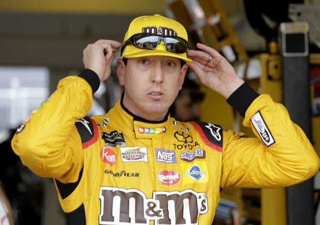 Kyle Busch adjusts his glasses during practice for the NASCAR Cup auto race at the Homestead-Miami Speedway on Friday in Homestead. [AP Photo/Terry Renna]
