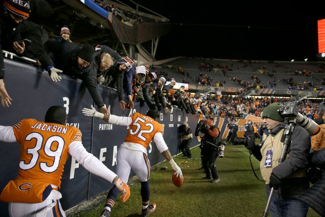 Chicago Bears linebacker Khalil Mack (52) and defensive back Eddie Jackson (39) celebrate with fans after an NFL football game Sunday, Nov. 18, 2018, in Chicago. The Bears won 25-20. (AP Photo/David Banks)