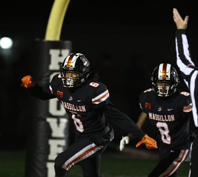 Massillon's Kyshad Mack celebrates his kickoff return for a touchdown with teammate Tyree Broyles during Friday's regional-final win over Wadsworth. (IndeOnline.com / Kevin Whitlock)