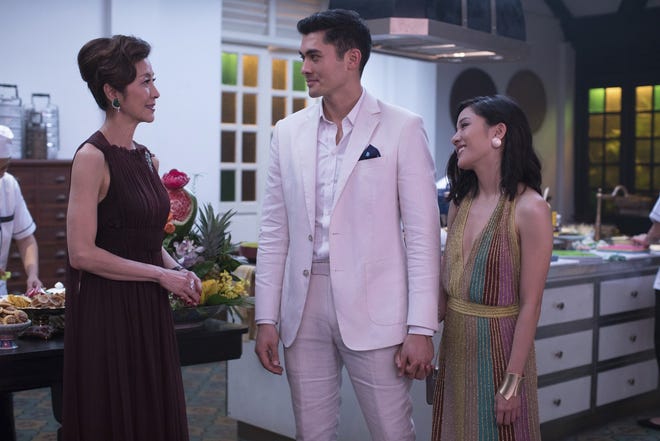 From left, Michelle Yeoh, Henry Golding and Constance Wu in a scene from the film "Crazy Rich Asians." [Sanja Bucko/Warner Bros. Entertainment via AP]