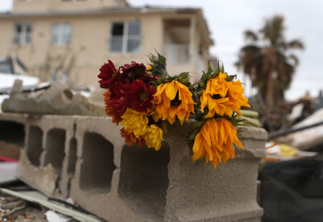 Flowers wilt on a cement block in the remains of Agnes Vicari's home on Nov.14 in Mexico Beach,Fla. [PATTI BLAKE/THE NEWS HERALD]