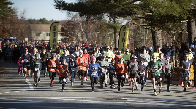 Hundreds of runners take off at the Garrison School for the annual Dover Turkey Trot 5k road race last Thanksgiving morning. [John Huff/Fosters files]