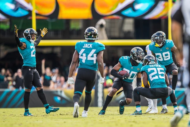 Jaguars players celebrate cornerback Jalen Ramsey's (20) interception in the second quarter of Sunday's 20-16 loss to the Steelers. [For The Florida Times-Union/James Gilbert]