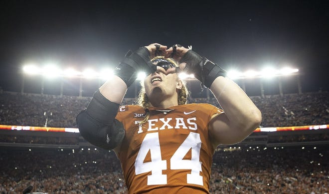 Texas defensive lineman Breckyn Hager (44) signals a heart sign to fans after the Longhorns' 24-10 win over Iowa State last Saturday. Minutes later, however, he made a disparaging remark about Oklahoma and on Monday was reprimanded by the Big 12. [NICK WAGNER/AMERICAN-STATESMAN]