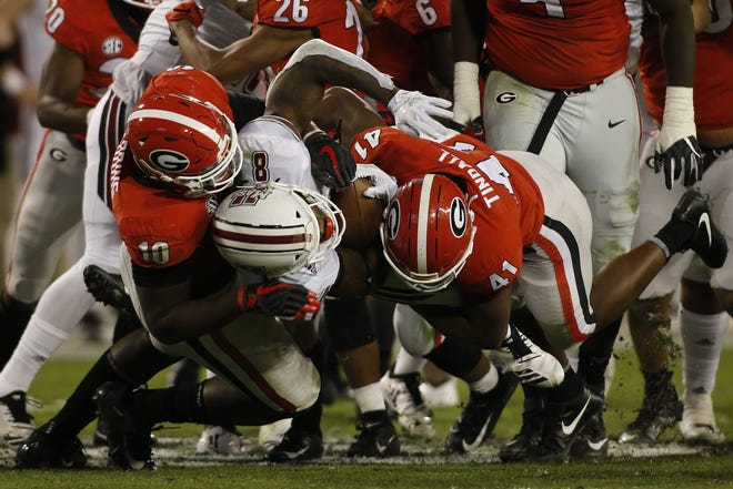 Georgia defensive end Malik Herring (10) and Georgia inside linebacker Channing Tindall (41) take down UMass running back Marquis Young (8) during the second half of the Bulldogs' win last Saturday. [Photo/Joshua L. Jones, Athens Banner-Herald]