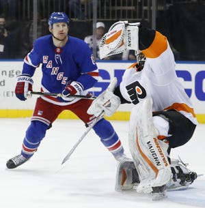 Flyers goalie Alex Lyon makes a glove save during a win over the Rangers last season. [AP FILE PHOTO]