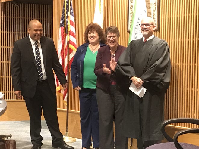 Ruben Colon, Jamie Haynes and Linda Cuthbert laugh with Judge James Clayton after being sworn in at their Nov. 20 meeting. [News-Journal/Cassidy Alexander]