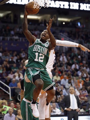 Celtics guard Terry Rozier shoots past Suns center Deandre Ayton during the first half of their game Nov. 8 in Phoenix. [Matt Newwork/AP]