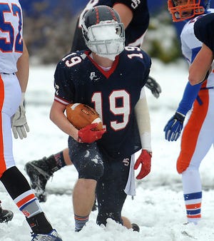 Eric Jones comes up with a facemask full of snow when he was a senior captain on the Lincoln-Sudbury football team during the Thanksgiving game against Newton South on Thanksgiving Day in 2014. [Daily News and Wicked Local Staff File Photo/Art Illman]