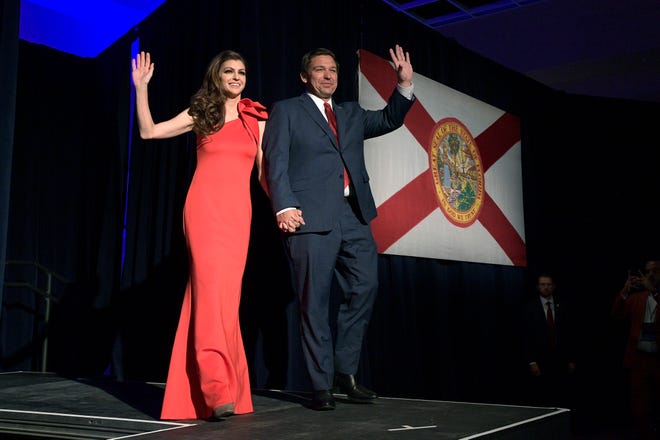 FILE- In this Nov. 6, 2018, file photo Florida Gov.-elect Ron DeSantis, right, and his wife Casey wave to supporters at his campaign party in Orlando, Fla. Trump-allied Republican DeSantis was formally elected governor of Florida and outgoing Gov. Rick Scott elected U.S. Senator on Tuesday, Nov. 20, 2018, when the state certified election results two weeks after tight margins prompted tumultuous recounts. (AP Photo/Phelan M. Ebenhack, File)