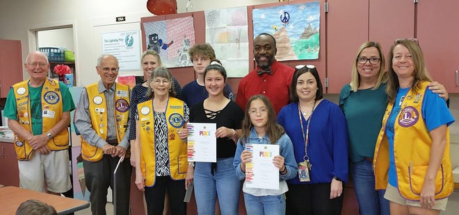 Laurel Nokomis School poster winners and Venice Lions Club members, back row, from left: Bill Davis and Rich Thierry, Lions Club; Heather Wasserman, assistant principal; Thomas Taylor, student; Ray Wilson, principal. Front row, from left: Lynn Thierry, Lions Club; Malia Love, student; Ellarose Sherman, student; Christine Oliver, assistant principal; Kristi Shakelford, art teacher; Shelley Devine, Lions Club. [COURTESY PHOTO]