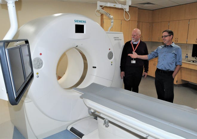 Dr. Brandon Black (right), diagnostic radiologist, and Rick McManemon, director of diagnostic imaging, show off a new computed tomography scanner. [CHIEFTAIN PHOTO/JON POMPIA]