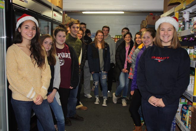 Natalie Dextradeur (front left) and Julia Buccella (front right), co-leaders of the Food Elves 2018 Campaign, hosted an open house and tour at the Franklin Food Pantry for a group of Food Elves to kick off this year’s holiday drive. [COURTESY PHOTO/PATTI DEXTRADEUR]