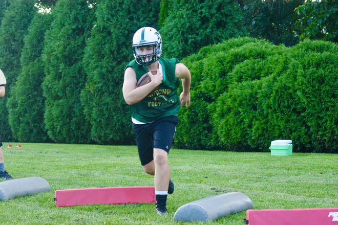 Matignon / St. Joseph’s Prep running back Kenneth Rezendes of Waltham, shown going through a running drill in a recent practice, has led by example at halfback this fall, and that has resulted in the Warriors’ first winning season in years. [Wicked Local Photo / Matt Noonan]
