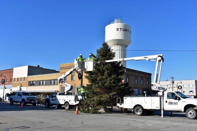 Story City Municipal Electric Company employees work on erecting and decorating the Christmas tree on Broad Street for a past year's Yulefest celebration. File photo/Ames Tribune