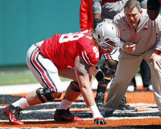 Ed Warinner, at the time on Ohio State's coaching staff, instructs offensive linesman Taylor Decker during the 2013 spring game. [Adam Cairns]