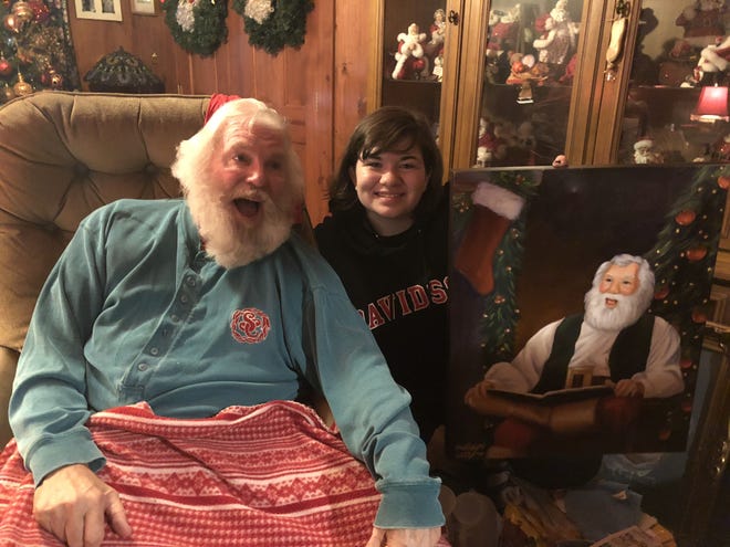 Madisyn Early, a junior at Highland School of Technology, visits Storybook Santa at his home with an oil painting she made of him. [MADISYN EARLY/SPECIAL TO THE GASTON GAZETTE]