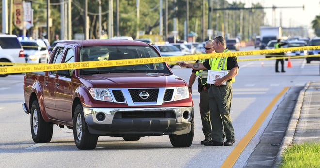 Investigators examine a truck involved in a fatal accident with a pedestrian on U.S. 441 at Sandalfoot Boulevard in 2014. [Lannis Waters /palmbeachpost.com]