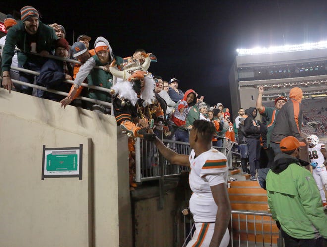 Quarterback N'Kosi Perry meets with fans after the Hurricanes victory at Virginia Tech Saturday that made Miami bowl eligible. (Matt Gentry/The Roanoke Times via AP)