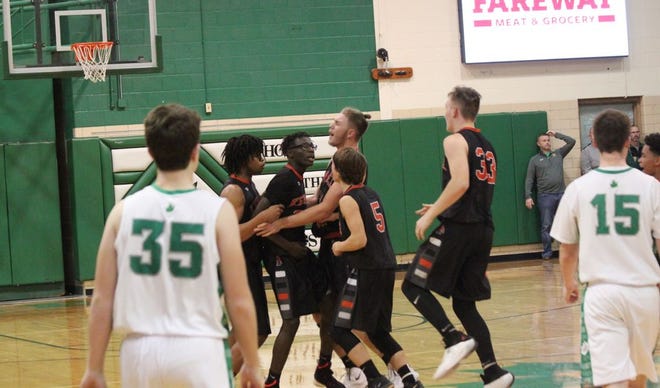 Kewanee's Kavon Russell is mobbed by his teammates following his game-winning three pointer over Geneseo Wednesday.