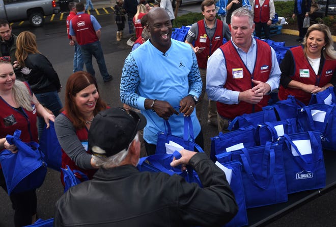 NBA legend and Wilmington native Michael Jordan hands out Thanksgiving meals to people impacted by Hurricane Florence at the Lowe's Home Improvement store in Wilmington, N.C., Tuesday, November 20, 2018.  [Matt Born/StarNews Photo]
