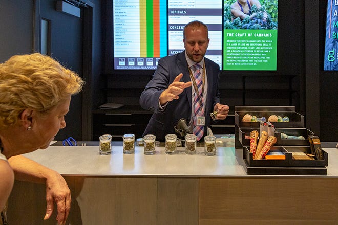 Steve Spinosa, president of operations at Good Chemistry, displays some of the sample cannabis strains at the opening event.