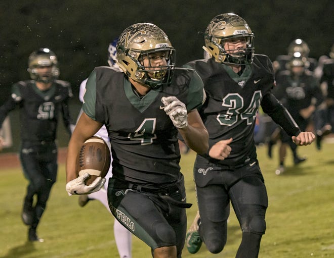 The Villages' Marcus Wright (4) runs with the ball during last week's Class 4A regional semifinal game against Gainesville P.K. Yonge in The Villages. [PAUL RYAN / CORRESPONDENT]