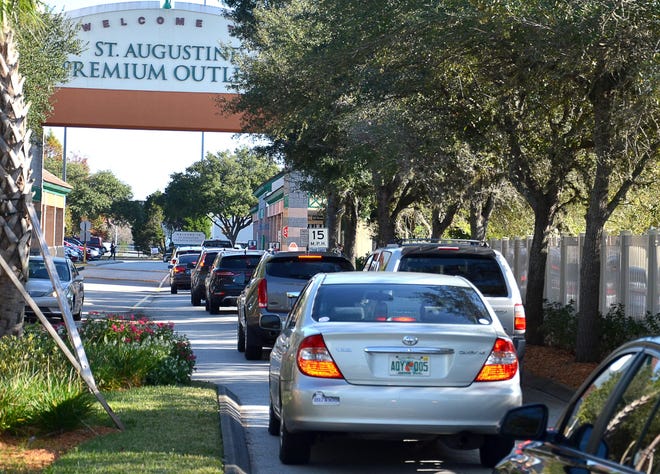 A long line of cars drive in to the St. Augustine Premium Outlets for Black Friday sales in November 2014. At this time every year, the Sheriff's Office deploys more deputies to the outlets and other high-volume shopping centers under its "holiday season merchant patrol." [PETER WILLOTT/THE RECORD]