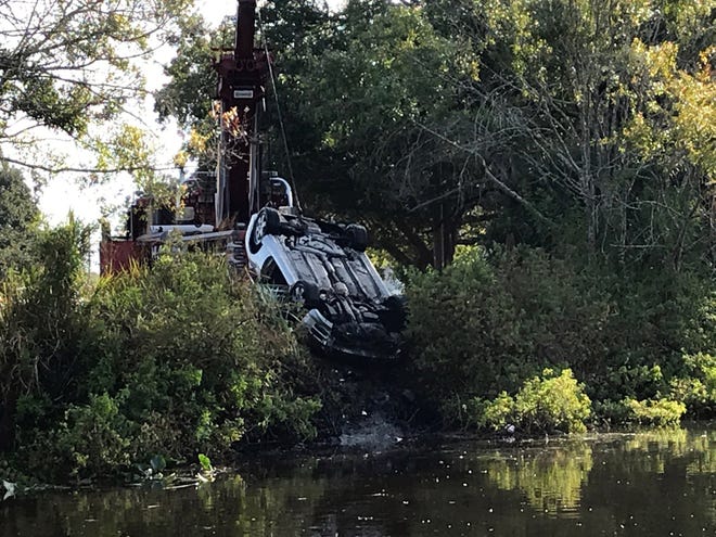 Emergency workers lift a white car from a pond near the 3700 block of Alden Way in south Sarasota on Thursday, Nov. 22, 2018. The condition of the driver is unknown. [Courtesy of Susie Chinn]