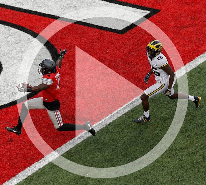 In this file photo Ohio State Buckeyes running back Curtis Samuel (4) runs past Michigan Wolverines cornerback Jourdan Lewis (26) to score the winning touchdown on a 15-yard run during the second overtime of the NCAA football game between the Ohio State Buckeyes and the Michigan Wolverines at Ohio Stadium on Saturday, November 26, 2016.
