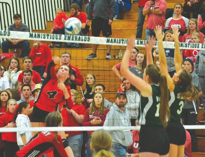 Onaway senior Calley Selke (4) delivers a hit during a Division 4 state quarterfinal contest against Carney-Nadeau in Manistique earlier this month. After a terrific final campaign with the Cardinals, Selke was named this year's Cheboygan Daily Tribune Volleyball Player of the Year.