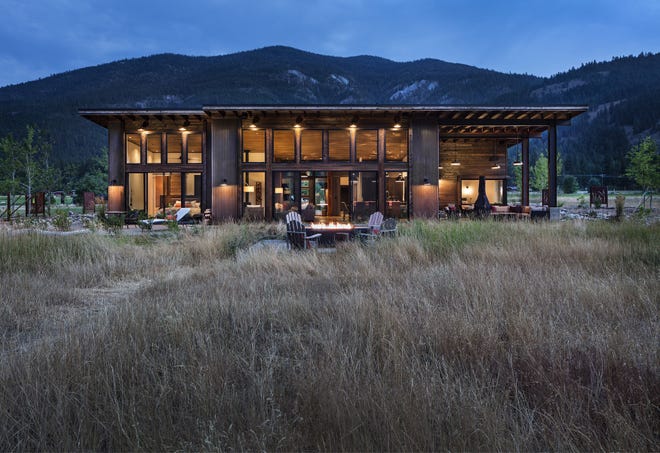 The backyard of the Sands family's Mazama home has a 500-pound steel firebox, views to forever and a path between tall grass leading directly to the Methow River. "The only drawback to this location is that not really until August can we use the river," says homeowner Colin Sands. "There's a lot of meltoff. But in mid-August, there's still water and a deep swimming hole. Unless there's bears. Black bears literally do backstrokes there." [Seattle Times / Steve Ringman]