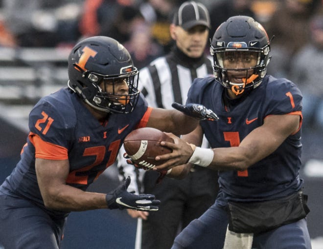 Illinois quarterback A.J. Bush, Jr. (1) hands off to running back Ra'Von Bonner in the first half against Iowa, Saturday, Nov. 17, 2018, in Champaign. The Fighting Illini will look to cap off a sub-par regular season with an upset win over Northwestern on Saturday. [HOLLY HART/THE ASSOCIATED PRESS]