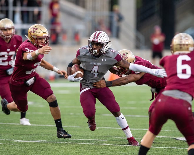 Round Rock quarterback Ryan O'Keefe (carrying the ball in the Dragons' bi-district win Nov. 17) was responsible for five touchdowns and had a combined 436 yards rushing, passing and receiving. [Henry Huey/For American-Statesman]