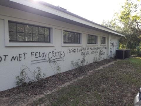 The messages scrawled across the back of a chiropractor's building in Eustis threaten more arsons in December. [SUBMITTED]
