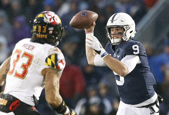Penn State quarterback Trace McSorley, right, looks to pass as Maryland's Tre Watson applies the pressure during the first half of a college football game in State College, Pa. on Saturday. [AP PHOTO/CHRIS KNIGHT]