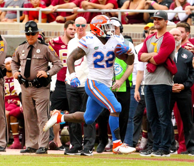 Gators running back Lamical Perine heads for the end zone on a 74-yard touchdown run in the second quarter against the Seminols at Doak Campbell Stadium in Tallahassee on Saturday. [Brad McClenny / The Gainesville Sun]