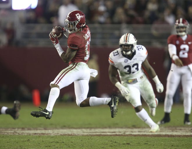 Alabama wide receiver Jaylen Waddle catches a pass and races to the end zone for a 53-yard touchdown against Auburn. [Staff Photo/Gary Cosby Jr.]