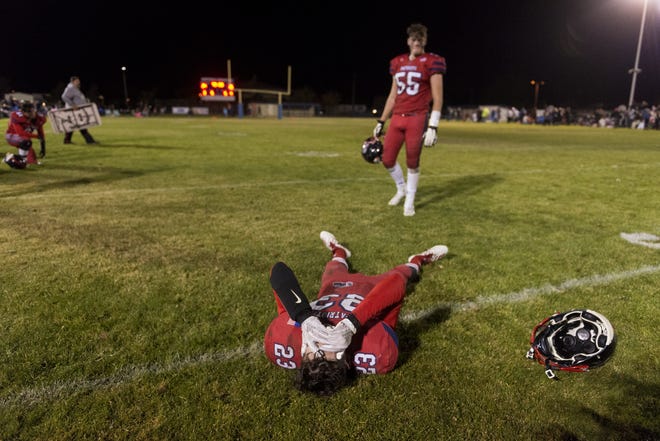 Hesperia Christian's Dylan Brigman lies on the ground after losing the CIF-Southern Section 8-Man Division 2 title game to Bloomington Christian in Hesperia on Saturday. [James Quigg, Daily Press]