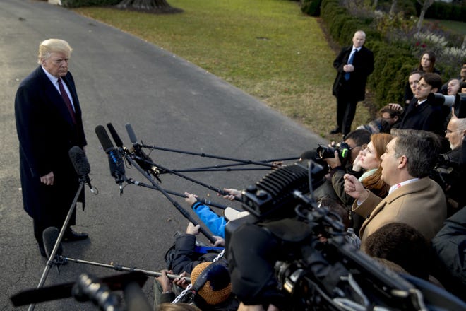 President Donald Trump takes a question from CNN reporter Jim Acosta, right, before boarding Marine One on the South Lawn of the White House in Washington, Tuesday, Nov. 20, 2018, for a short trip to Andrews Air Force Base, Md., and then on to Palm Beach Fla. [ ANDREW HARNIK / AP ]