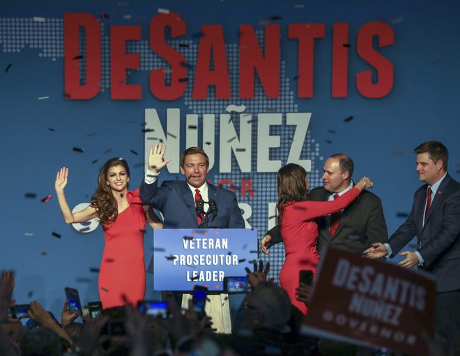 Republican Florida Governor-elect Ron DeSantis, center, waves to the supporters with his wife, Casey, left, and Republican Lt. Governor-elect Jeanette Nunez, third right, after thanking the crowd on election night. (Chris Urso/Tampa Bay Times via AP)