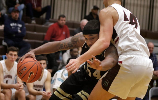Bryant forward SaBastian Townes puts his head down and tries to drive past Brown defender Matt DeWolf on his way to the hoop during the game Sunday evening at the Pizzitola Sports Center.