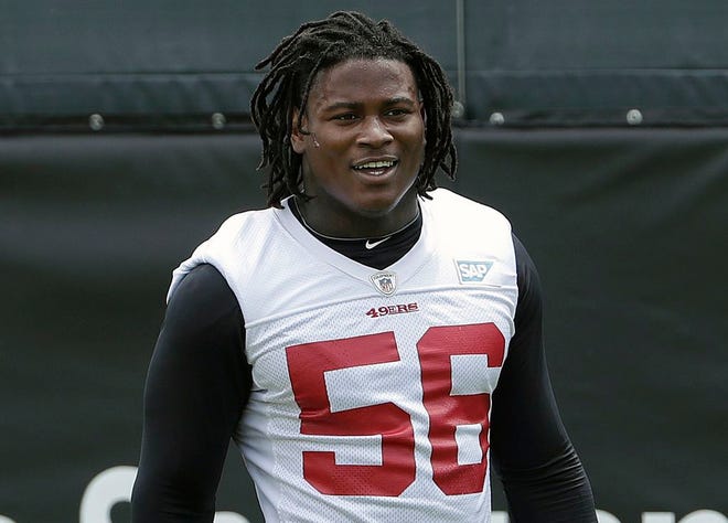 In this 2018 file photo, San Francisco 49ers linebacker Reuben Foster walks on the field during a practice at the team's NFL football training facility in Santa Clara, Calif. Foster was arrested Saturday, Nov. 24, at the team hotel on charges of domestic violence.