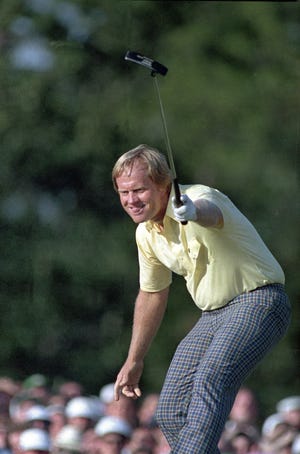 Jack Nicklaus watches his putt go in for a birdie on the 17th hole at the Masters on April 13, 1986, in Augusta, Ga. He wore a yellow shirt that day to honor a young fan who died at a young age from cancer. [AP Photo/Joe Benton, File]