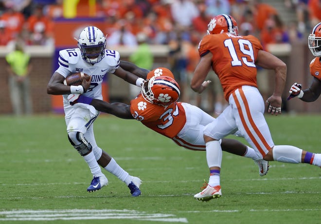 Furman quarterback JeMar Lincoln is pursued by Clemson's J.D.Davis, center, and Tanner Muse during the first half of an NCAA college football game Saturday, Sept. 1, 2018, in Clemson, S.C. (AP Photo/Richard Shiro)