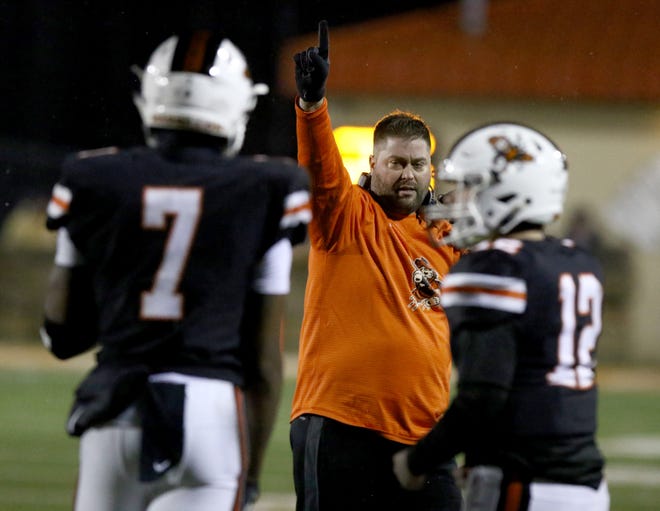 Massillon coach Nate Moore signals for his team to kick the point after touchdown during a regional-semifinal win over Whitehall-Yearling. (IndeOnline.com/ Kevin Whitlock)