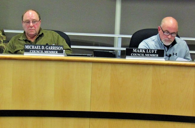 Pekin City Council members Michael Garrison (left) and Mark Luft (right) listen to public input during Monday’s meeting.